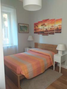a bedroom with a bed with two tables and two lamps at B&B Acquamarina in Lido di Ostia