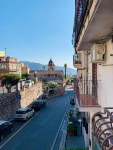 a view of a city street with cars parked on the road at Pancrazio in Taormina