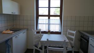 a kitchen with a table and chairs and a window at Rittergut zu Groitzsch in Jesewitz