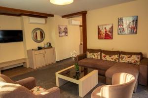 a living room with a couch and a table at Boutique hotel Provence Бутик хотел Прованс in Petrich
