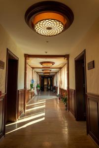 a hallway in a building with a large ceiling at Boutique hotel Provence Бутик хотел Прованс in Petrich