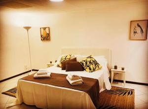 a bedroom with a large bed with pillows on it at Pancrazio in Taormina