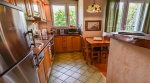 a kitchen with a refrigerator and a table in it at Rent like home - Słoneczna 3 in Zakopane