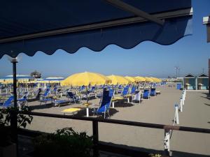 a bunch of chairs and umbrellas on a beach at B&B Acquamarina in Lido di Ostia
