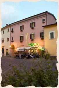 a large building in front of a building at Hotel Centrale in Cascia