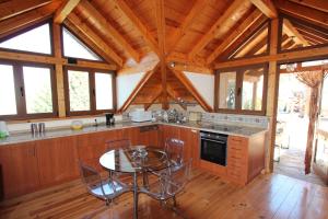 una cocina con mesa y sillas en una cabaña en ViVaTenerife - Retreat in nature, SPA and wellness en Tejina de Isora