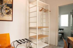 a white book shelf in the corner of a room at Maddrigga di Luna in Selargius
