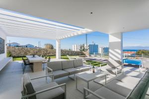 a patio with a couch and chairs and a table at The Villa / Ericeirahills in Ericeira