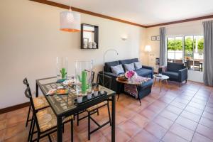 a living room with a couch and a table at Terraços de Benagil 23 (Casa Alvorada) in Benagil