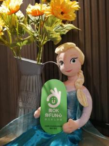 a figurine of a mermaid standing next to a vase with flowers at Urbanone Hotel in Taipei