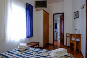 1 dormitorio con 1 cama con toallas en Rimavier Residence, en Peniche