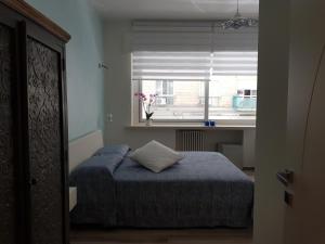 a small bedroom with a bed and a window at RosAmar in Bari