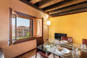 a dining room with a table and a window at Doge Morosini Palace in Venice