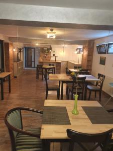 a dining room with wooden tables and chairs at Hotel Belleville in Iaşi