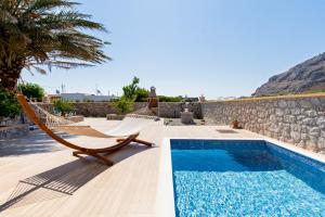 a resort with a pool and hammocks and a rock wall at Stergios summer dream house in Kolymbia