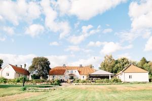 a house with a field in front of it at Lidö Värdshus in Lidö