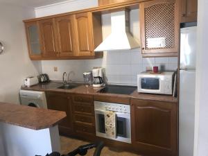 a kitchen with a sink and a stove top oven at Playamarina 2 Cabo Roig in Playas de Orihuela