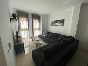 a living room with a couch and a table at SWEET HOME AYAMONTE in Ayamonte