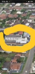 an overhead view of a city with a yellow arrow at Pousadas Mafra in Mafra