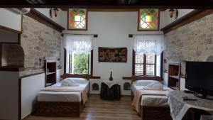 Ένα ή περισσότερα κρεβάτια σε δωμάτιο στο RIVA Guest House