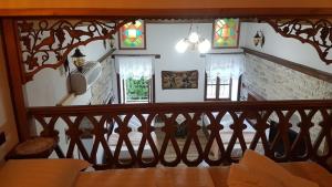a room with a staircase with stained glass windows at RIVA Guest House in Gjirokastër
