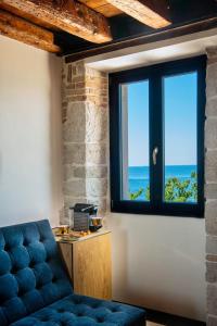 a room with a couch and a window at Spirito Santo Palazzo Storico in Rovinj