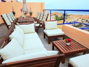 a balcony with chairs and tables and a view at Panoramic Atalaya in Mojácar