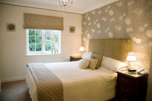 a bedroom with a large bed and a window at Rivermount House in Kinsale