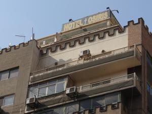 a building with a sign on the top of it at Osiris Hotel Cairo in Cairo