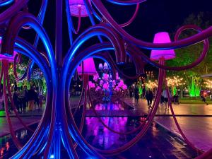 a group of people walking around a fountain at night at Villa Rosa Béziers in Béziers