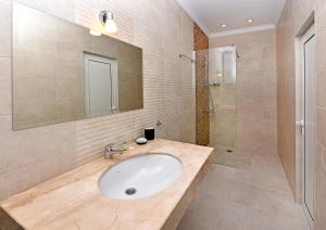 a bathroom with a sink and a shower at Sirena Palace Family Hotel in Obzor