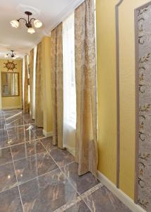 a hallway of a home with yellow walls and curtains at Sirena Palace Family Hotel in Obzor