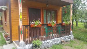 a house with a fence with flowers on it at Садиба Гуцулка Ксеня in Yaremche