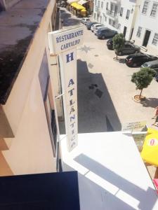 a sign for a restaurant on the side of a building at Hotel Atlântica in São Martinho do Porto