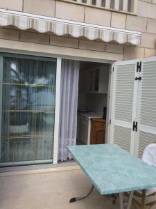 a patio with a table and a sliding glass door at Sun Residence Brela in Brela