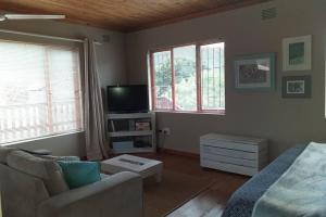 a living room with a couch and a tv at Whale of a Time - Sedgefield in Sedgefield