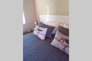 a room with a bed with two pillows on it at Whale of a Time - Sedgefield in Sedgefield