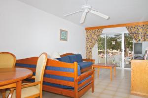 a living room with a blue couch and a table at Hotel Riu Oliva Beach Resort - All Inclusive in Corralejo
