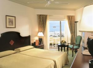 a hotel room with a bed and a balcony at Hotel Riu Oliva Beach Resort - All Inclusive in Corralejo