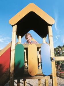 a young girl is on a slide on a playground at Hotel Riu Oliva Beach Resort - All Inclusive in Corralejo