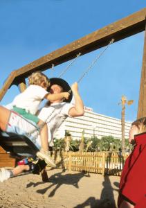 a group of people sitting on a swing at Hotel Riu Oliva Beach Resort - All Inclusive in Corralejo