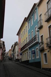 a row of colorful buildings on a city street at Hotel Zenite in Angra do Heroísmo