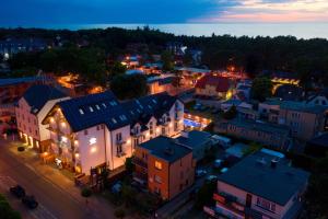 eine Luftansicht einer Kleinstadt in der Nacht in der Unterkunft Pod Winogronem - Apartamenty z basenem i wyżywieniem in Pobierowo