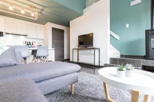 a living room with a couch and a table at La Cabane d'Hujulo in Malmedy