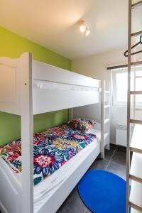 a bedroom with two bunk beds in a room at La Cabane d'Hujulo in Malmedy