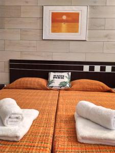 sypialnia z 2 łóżkami i ręcznikami w obiekcie Apartamento Garcey w mieście Ajuy