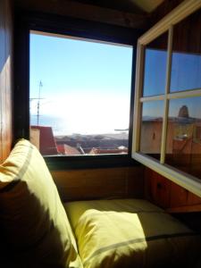 a bed in a room with a large window at Alfama Apartment in Lisbon