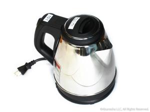 a black and white tea kettle on a white background at Oyado Midokoi in Akune