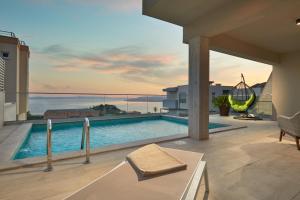 a swimming pool on the roof of a house at Sun Spalato Villas in Makarska
