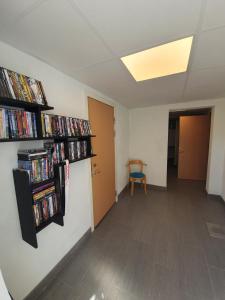 a room with two shelves filled with dvds at Byxelkrok, Solis in Byxelkrok